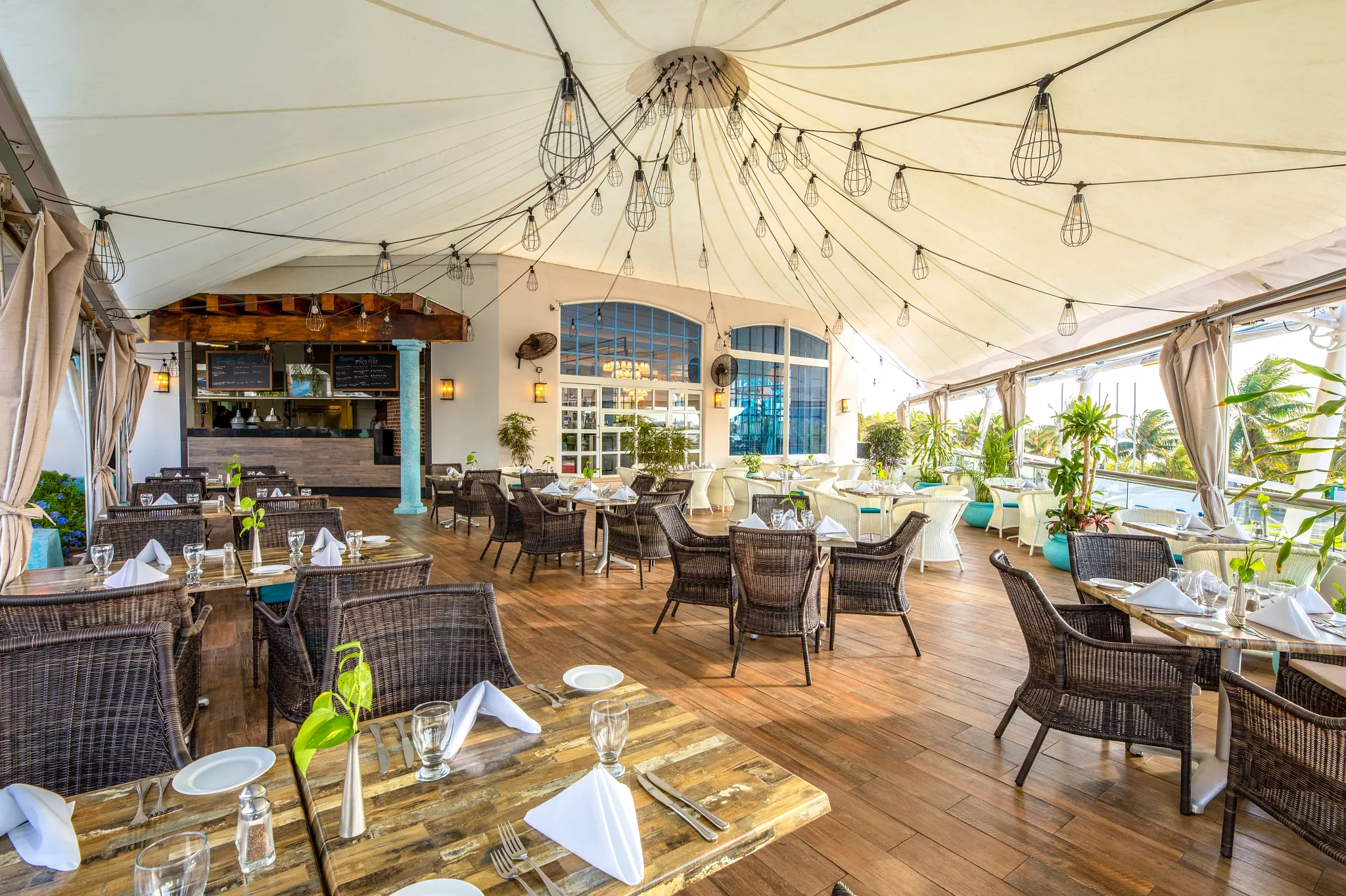 At Sunset bar at Sunscape Cancun Resort & Spa featuring oceanfront seating, tropical cocktails, and scenic sunset views over the Caribbean Sea.