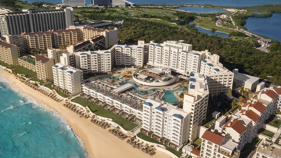 Hilton Cancun Mar Caribe all-inclusive resort with modern pools, beachfront setting, and family amenities in Cancun Hotel Zone.