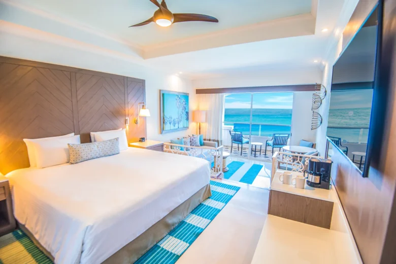 Oceanfront Junior Suite with king bed and private balcony at Sunscape Cancun Resort & Spa.